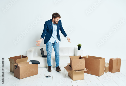 manager in a suit with cardboard boxes of things moving to a new place of work © SHOTPRIME STUDIO