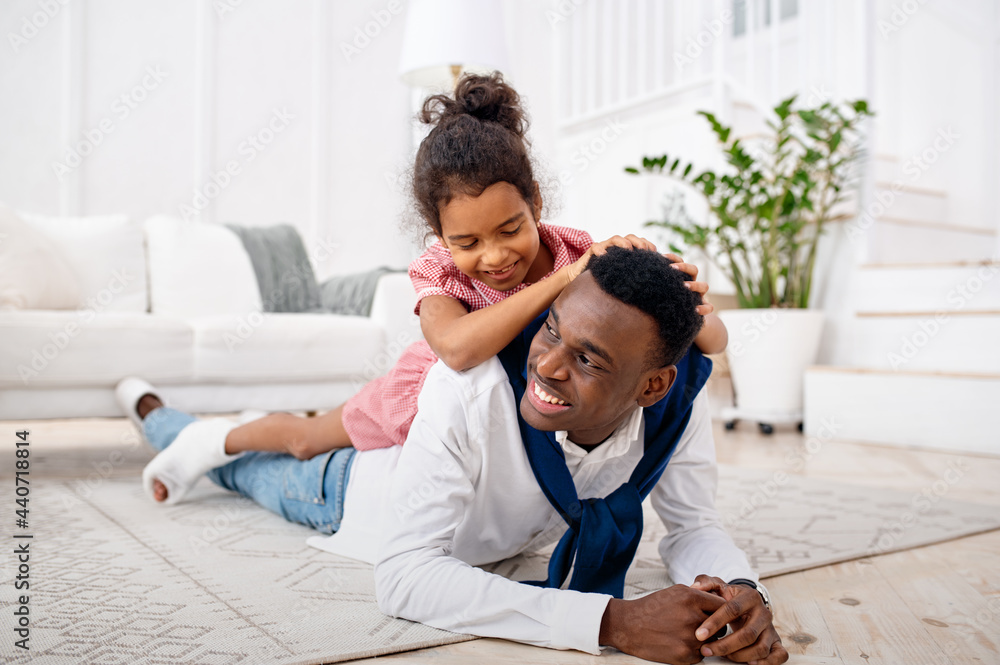 Smiling father and little daughter in living room Smiling father and little daughter in living room