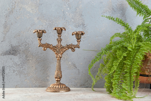 Antique candlestick on concrete background