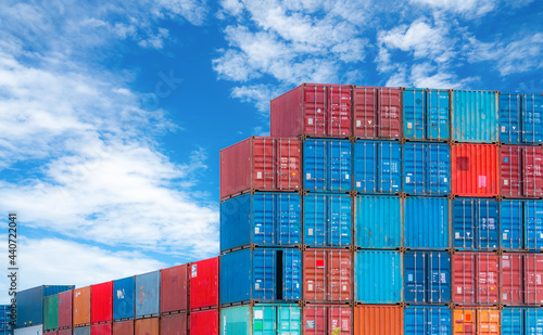 Red and blue logistic container against blue sky. Cargo and shipping business. Container ship for import and export logistics. Logistic industry. Container for truck transport and air logistic.