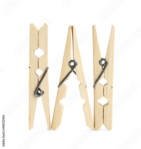 Three classic wooden clothespins on white background