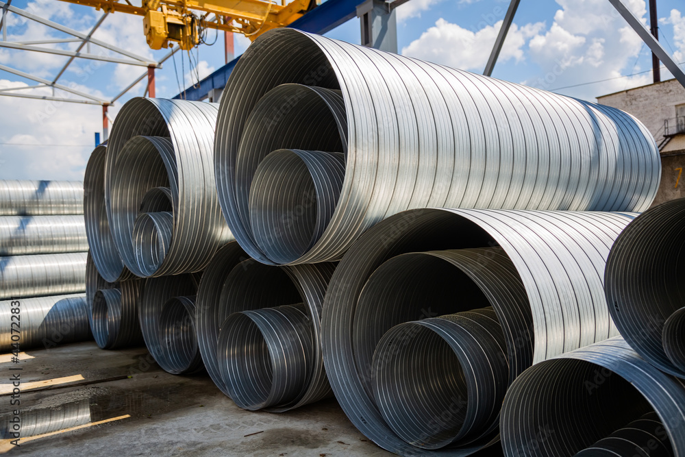 Ventilation pipe warehouse. Steel pipes, parts for the construction of air ducts for an industrial air conditioning system in a warehouse. Industrial airway ventilation equipment and piping systems Ventilation pipe warehouse. Steel pipes, parts for the construction of air ducts for an industrial air conditioning system in a warehouse. Industrial airway ventilation equipment and piping systems