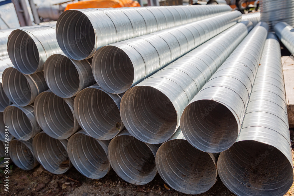 Ventilation pipe warehouse. Steel pipes, parts for the construction of air ducts for an industrial air conditioning system in a warehouse. Industrial airway ventilation equipment and piping systems Ventilation pipe warehouse. Steel pipes, parts for the construction of air ducts for an industrial air conditioning system in a warehouse. Industrial airway ventilation equipment and piping systems