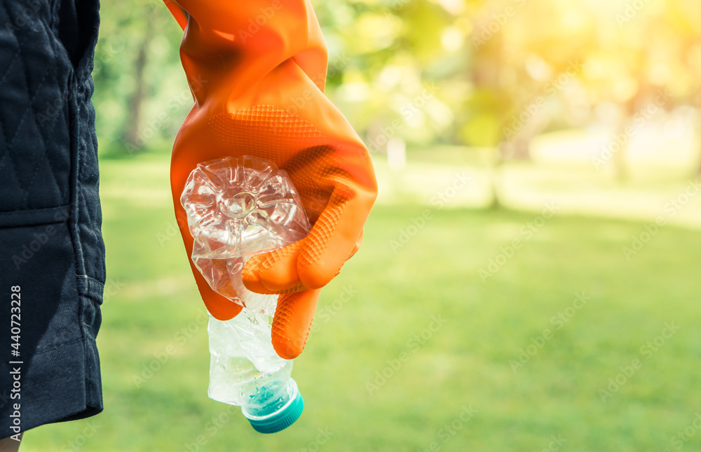 Volunteer woman collecting trash.Garbage bottles picked up. Plastic and