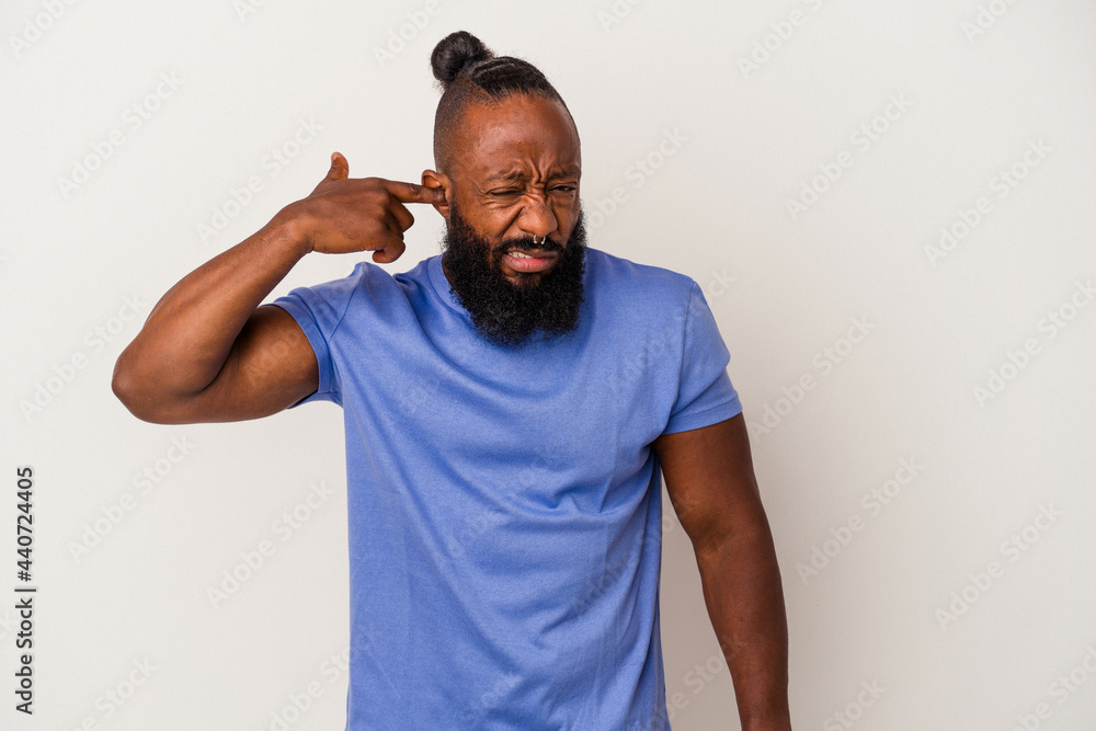 African american man with beard isolated on pink background covering ears with hands. African american man with beard isolated on pink background covering ears with hands.