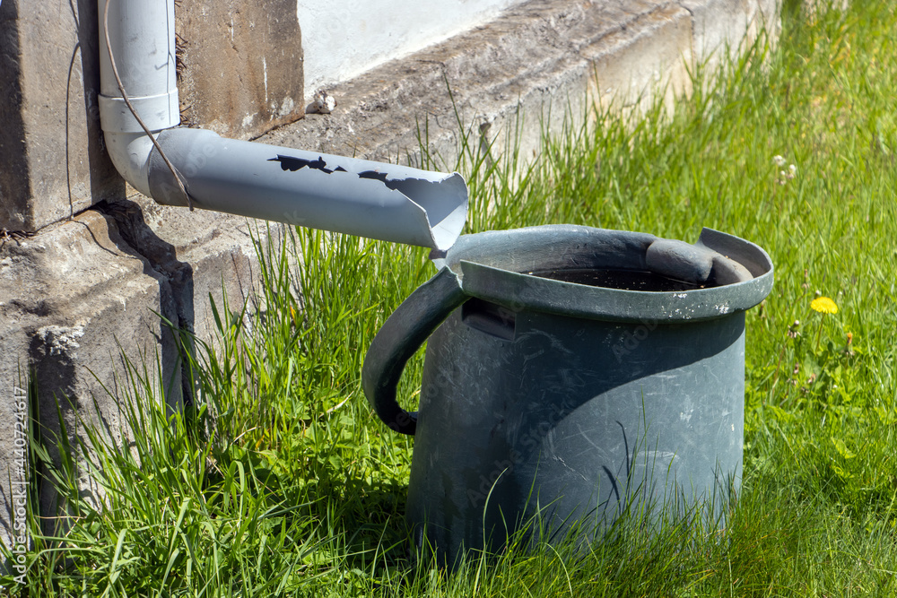 A full tank of rainwater under the gutter A full tank of rainwater under the gutter