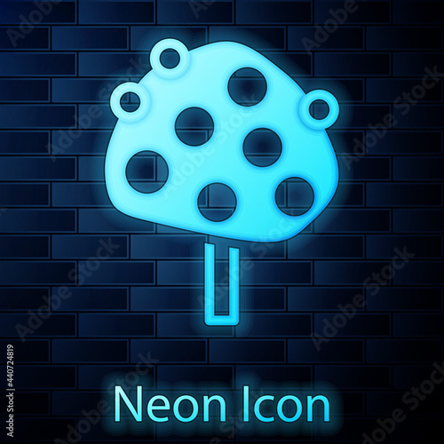 Glowing neon Orange tree with fruits icon isolated on brick wall background. Vector