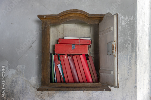 The religious literature in the old library hanging on the wall in the sacristy of the church. photo