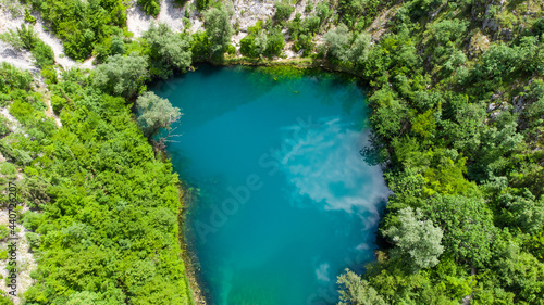 Aerial drone view of river source. Beautiful green river and forest in spring. 
