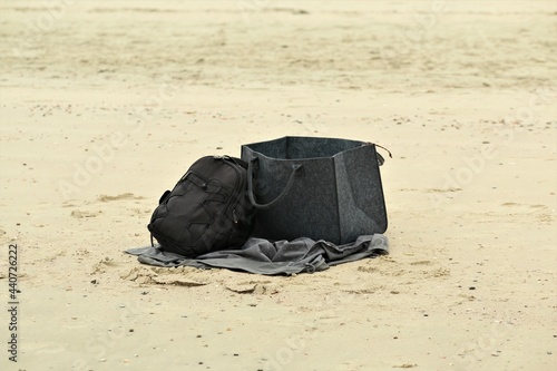 Black backpack and a grey big bag at the beach © Luise123