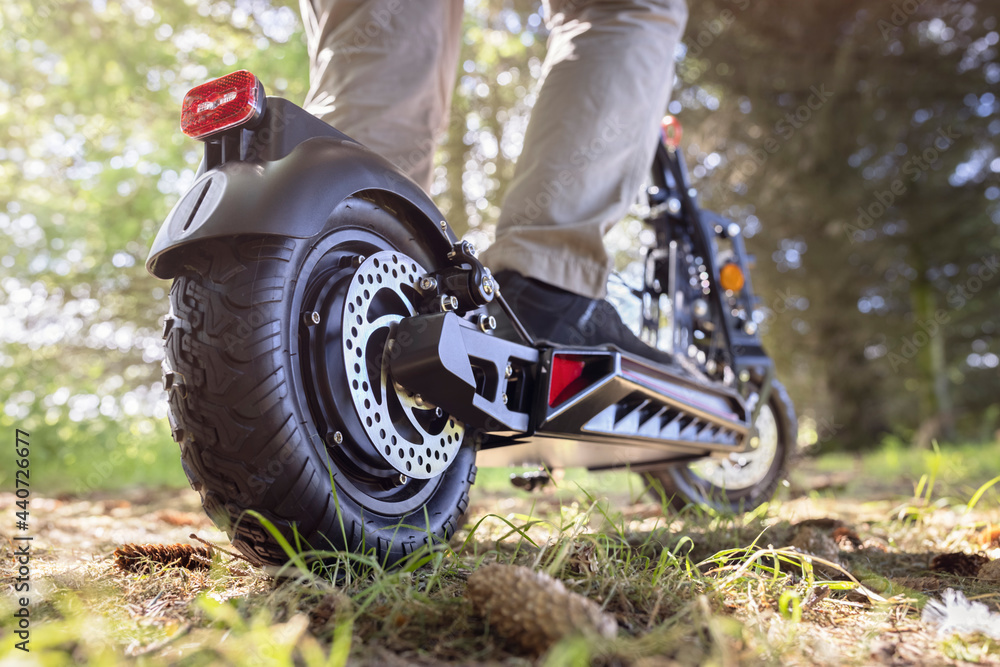 Electric scooter or e-scooter off road on a forest track Photos | Adobe  Stock