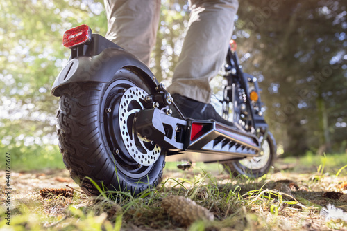 Electric scooter or e-scooter off road on a forest track