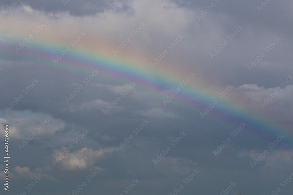Rainbow above the north sea against a blue sky with clouds Rainbow above the north sea against a blue sky with clouds