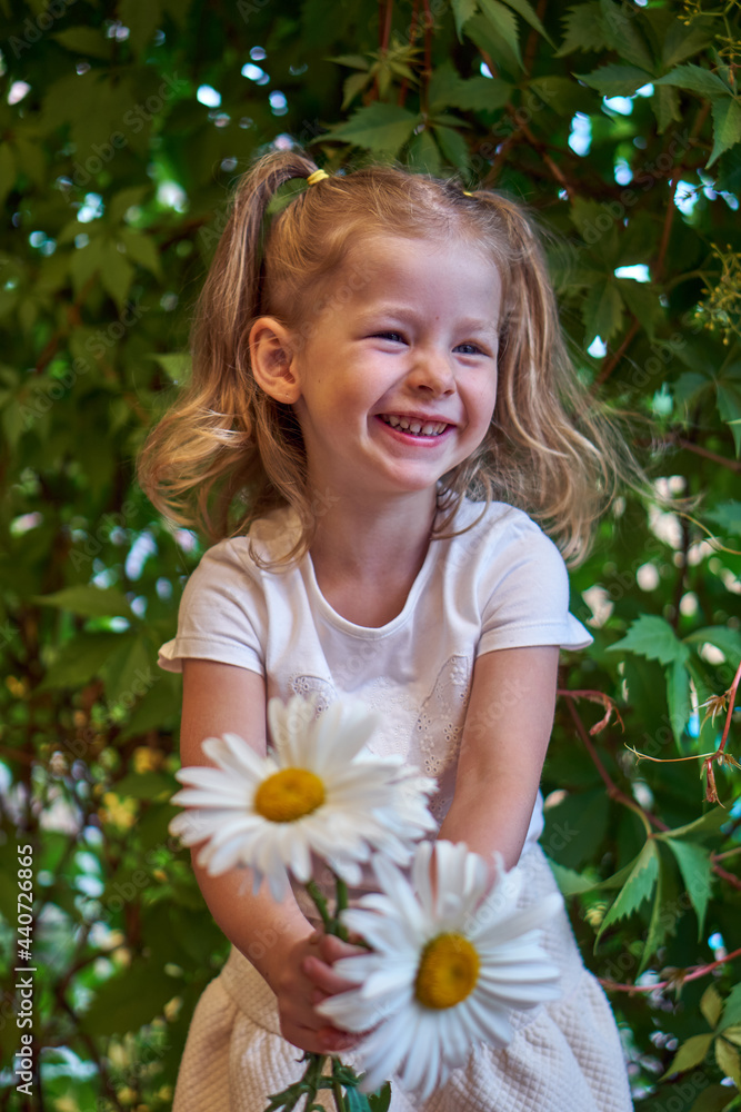 custom made wallpaper toronto digitalCute beautiful girl with flower holding a big white chamomile flower. Child in nature in the grass.