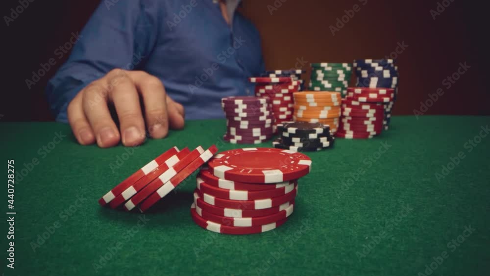 Male player betting all chips in while playing in casino, close up Male player betting all chips in while playing in casino, close up
