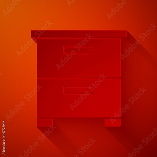 Paper cut Furniture nightstand icon isolated on red background. Paper art style. Vector