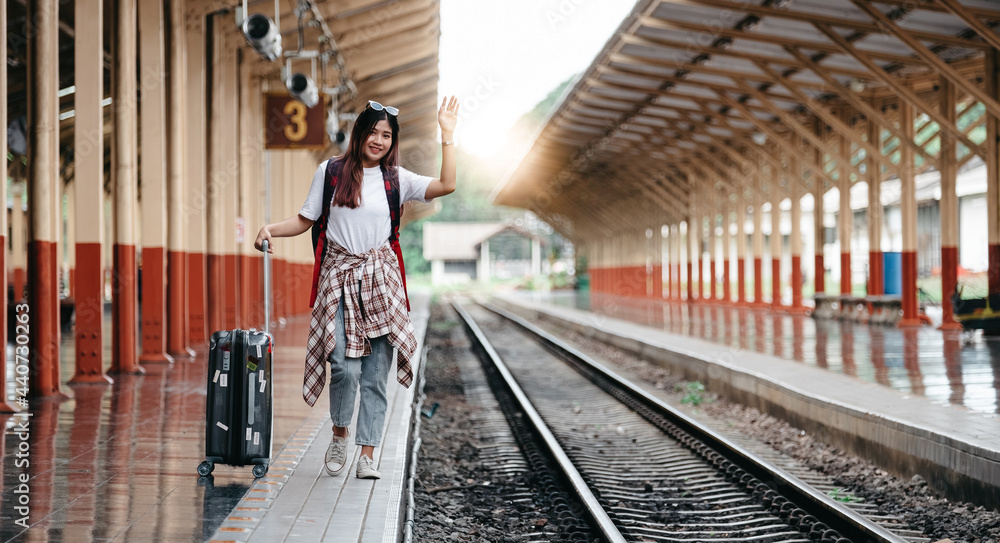 Portrait traveler assian woman walking and waits train on railway platform. Portrait traveler assian woman walking and waits train on railway platform.