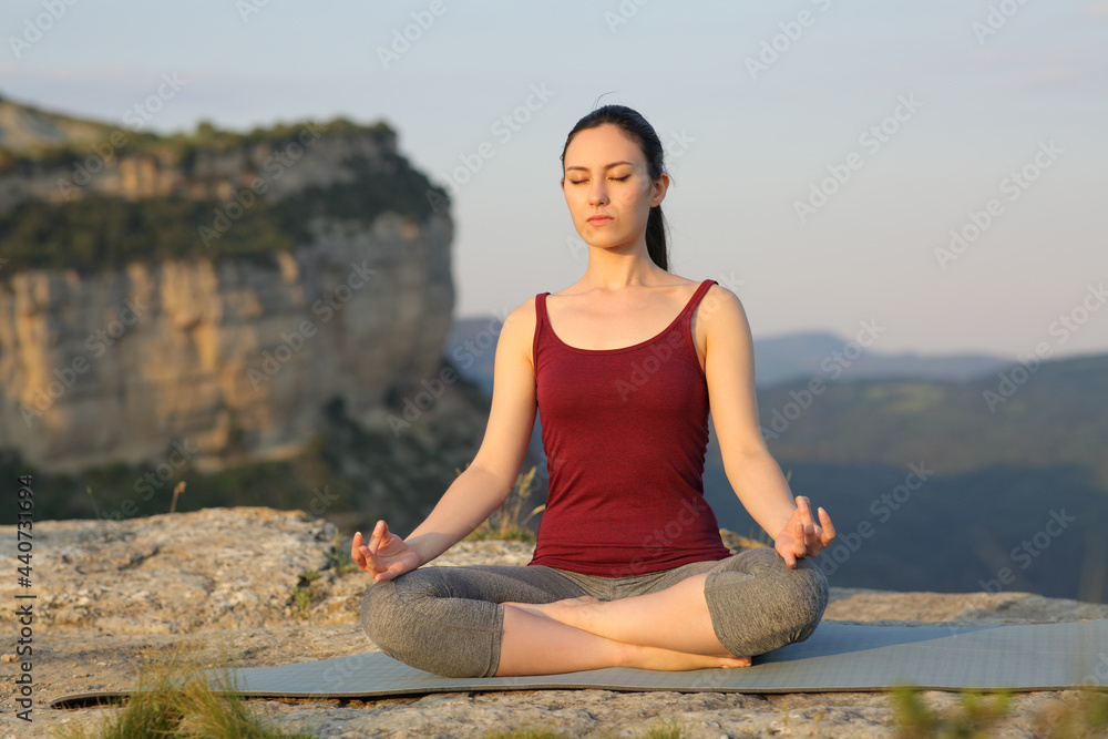 Mixed race woman doing yoga exercise in the mountain