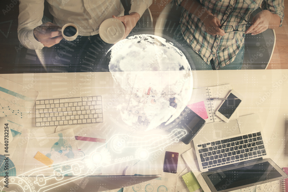 Double exposure of man and woman working together and world map hologram drawing. international network concept. Computer background. Top View. Double exposure of man and woman working together and world map hologram drawing. international network concept. Computer background. Top View.