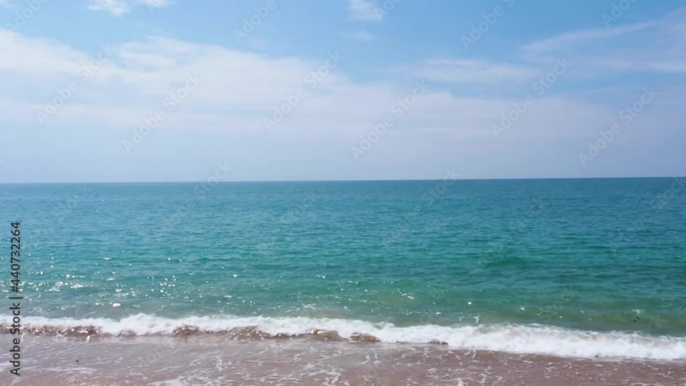 paradise in sunny weather, blue sky white clouds at the beach. beautiful foaming ocean waves crashing on sandy shore. sunlight sparkling on seawater surface. traveling and relaxing in summer vacation paradise in sunny weather, blue sky white clouds at the beach. beautiful foaming ocean waves crashing on sandy shore. sunlight sparkling on seawater surface. traveling and relaxing in summer vacation