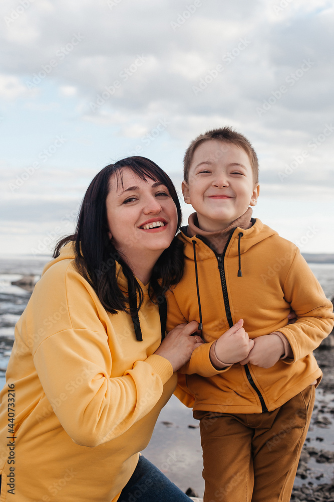 Mom and son on the river bank.