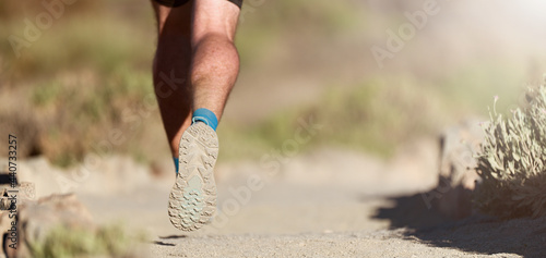 Trail running in summer sunshine concept for exercising, fitness and healthy lifestyle