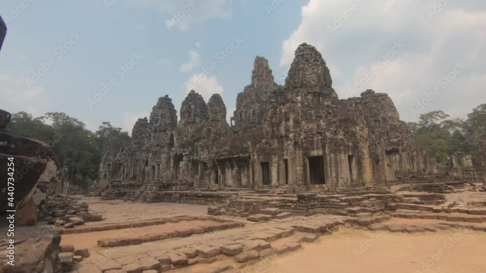 Reveal of carved walls of Angkor Wat stone temple, against blue sky. Historical religious site. Reveal of carved walls of Angkor Wat stone temple, against blue sky. Historical religious site.