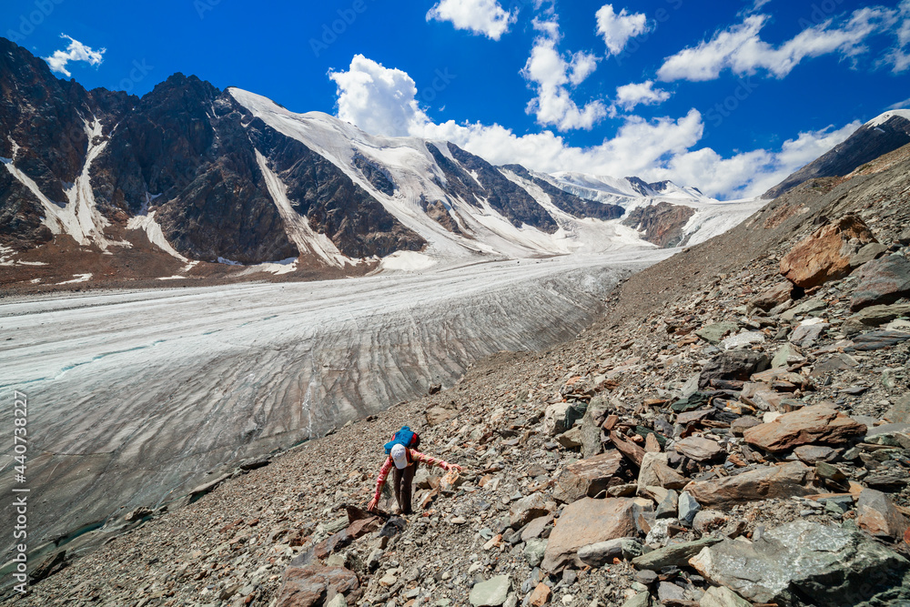 A tourist climbs to the top of the Bolshoy Aktru glacier, Altay, Russia.
