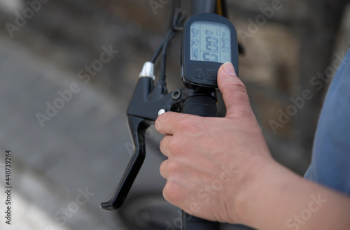 manipulating the digital speedometer of the bicycle