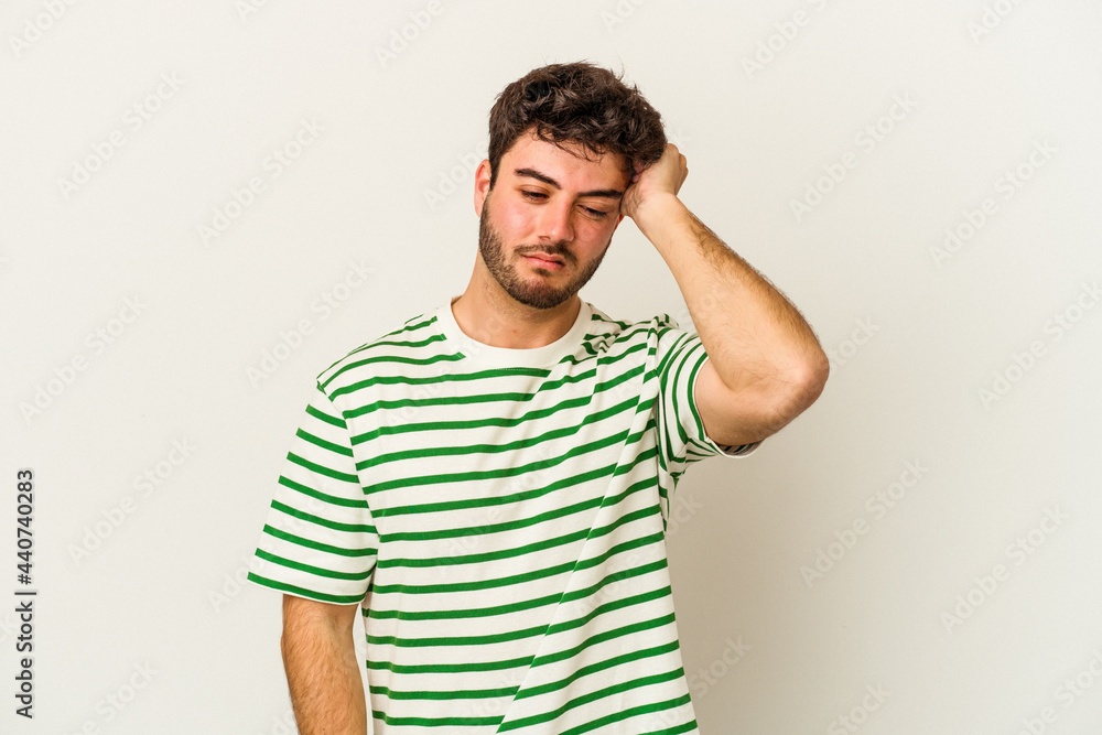 Young caucasian man isolated on white background forgetting something, slapping forehead with palm and closing eyes.