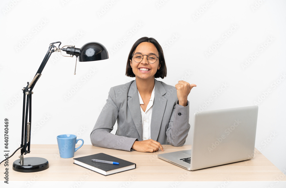 Young business mixed race woman working at office pointing to the side to present a product Young business mixed race woman working at office pointing to the side to present a product