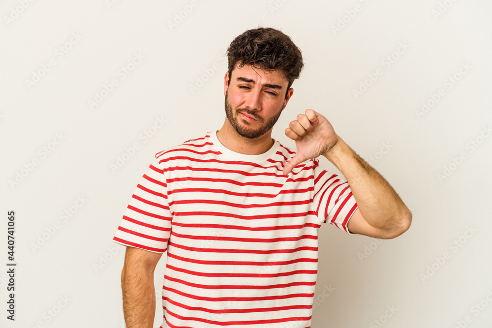 Young caucasian man isolated on white background showing thumb down, disappointment concept. Young caucasian man isolated on white background showing thumb down, disappointment concept.