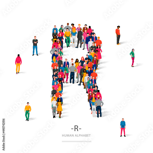A large group of people is standing in colored clothes in the shape of the letter R. The concept of the human alphabet.