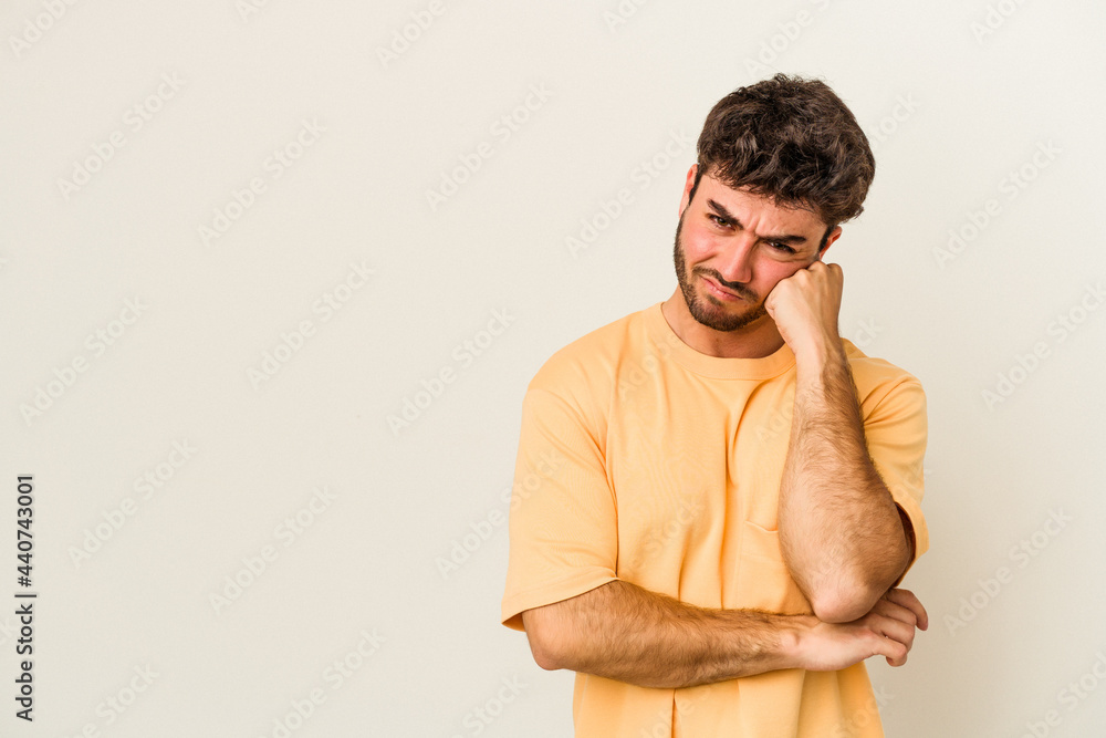 Fototapeta premium Young caucasian man isolated on white background who feels sad and pensive, looking at copy space.