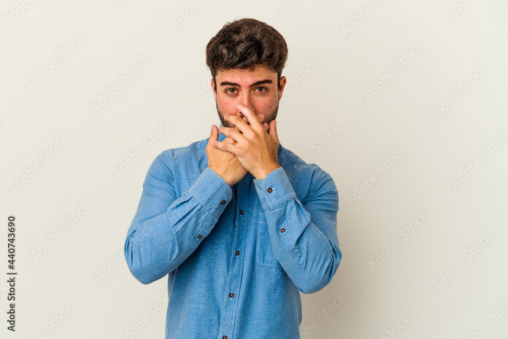 Young caucasian man isolated on white background covering mouth with hands looking worried. Young caucasian man isolated on white background covering mouth with hands looking worried.