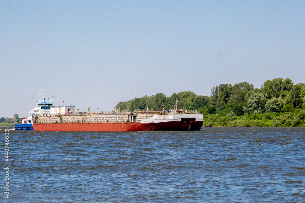 river tug pushing a barge