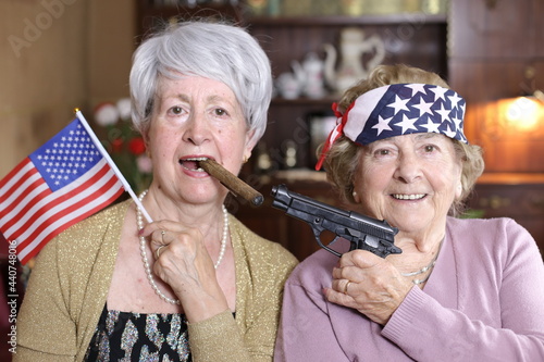 American ladies holding a gun and smoking a cigar