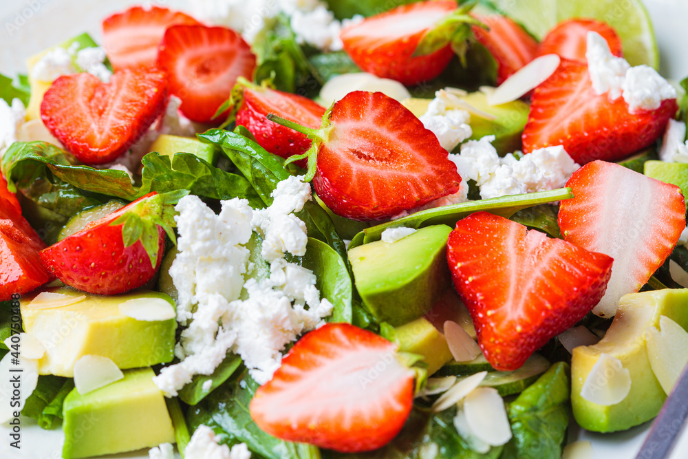 Close-up of strawberry salad with spinach, feta cheese, avocado and almonds. Close-up of strawberry salad with spinach, feta cheese, avocado and almonds.