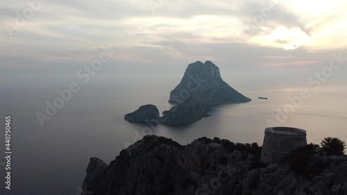 A drone view of the Torre des Savinar surrounded by the sea in Es Vedra, Spain shot in HD photo