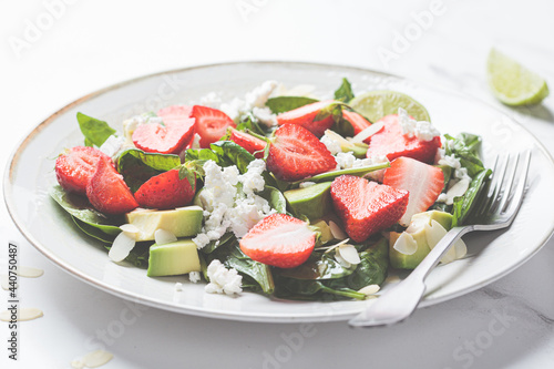 Strawberry salad with spinach, feta cheese, avocado and almonds.
