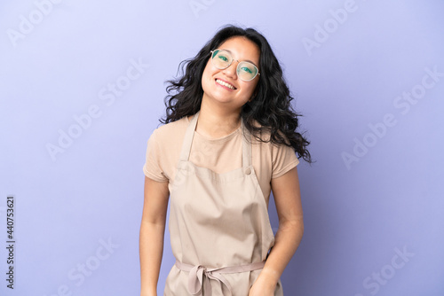 Restaurant asian waiter isolated on purple background with glasses and happy