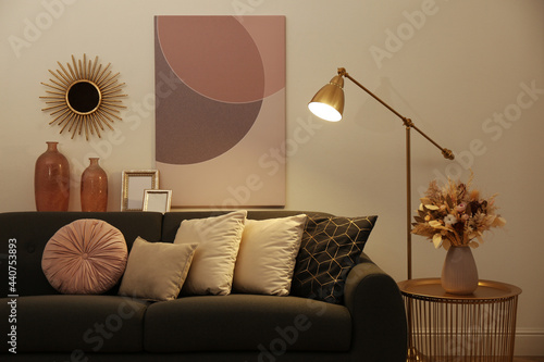 Stylish living room interior with comfortable sofa and floor lamp photo