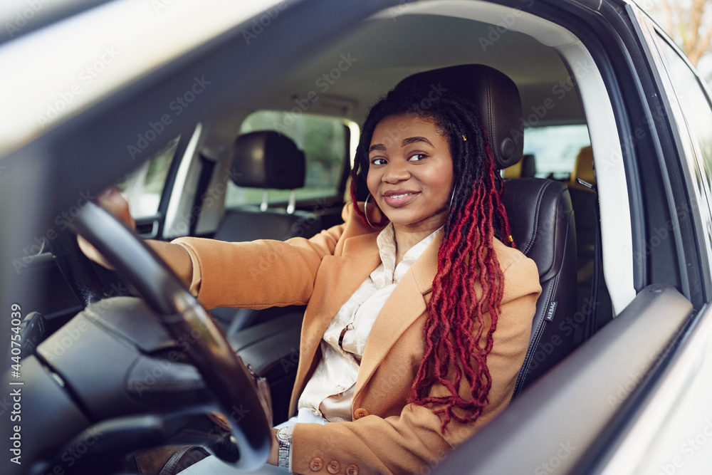 Portrait of positive african american lady inside the car Portrait of positive african american lady inside the car