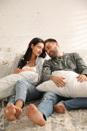 Happy young couple resting after fun pillow fight in bedroom © New Africa