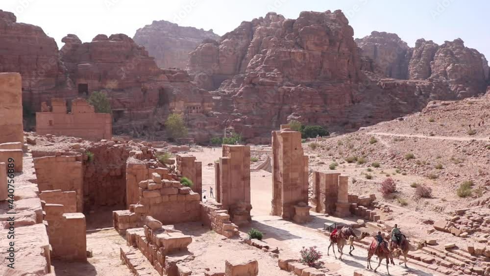Ancient Ruins in Jordan with Cameleers Riding Ancient Ruins in Jordan with Cameleers Riding
