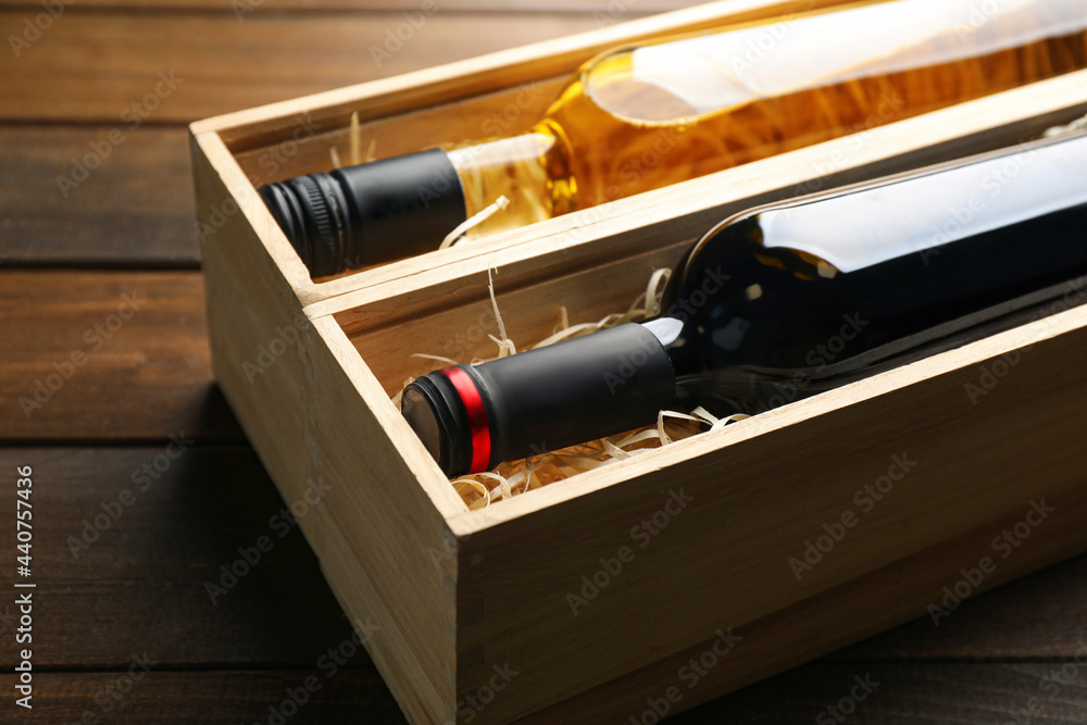 Boxes with bottles of wine on wooden background, closeup Boxes with bottles of wine on wooden background, closeup