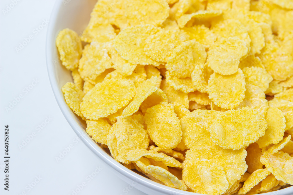 Plate with cornflakes on a white background. Healthy and tasty breakfast. Plate with cornflakes on a white background. Healthy and tasty breakfast.