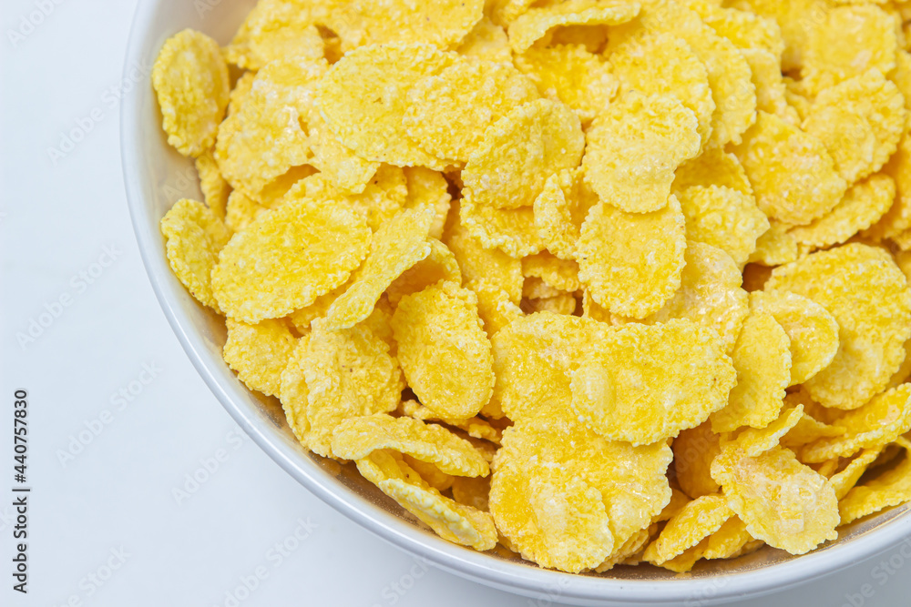 Plate with cornflakes on a white background. Healthy and tasty breakfast. Plate with cornflakes on a white background. Healthy and tasty breakfast.