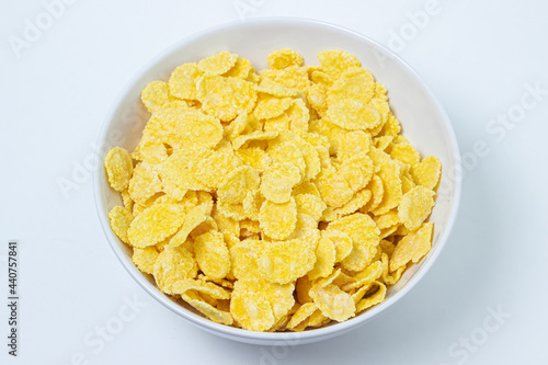 Plate with cornflakes on a white background. Healthy and tasty breakfast.