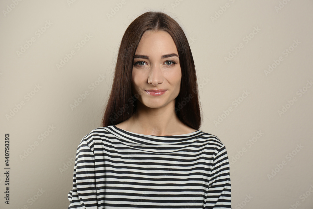 Portrait of pretty young woman with gorgeous chestnut hair on light background Portrait of pretty young woman with gorgeous chestnut hair on light background